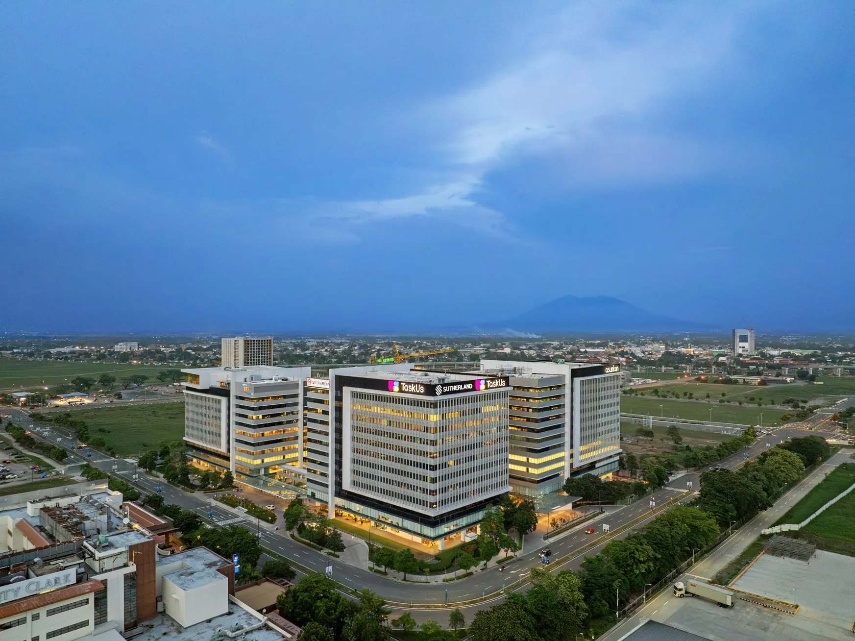 Aerial dusk view of the West Aeropark office towers at Clark Global City, with Mount Arayat in the background